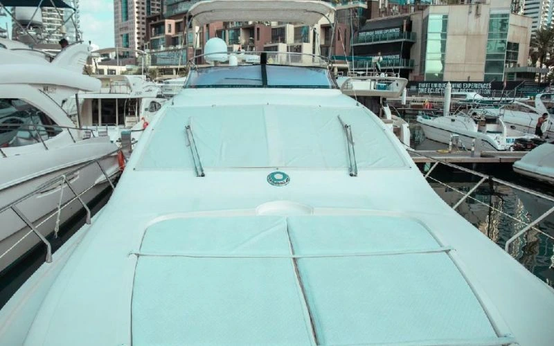 سطح أمامي فسيح وجذاب في يخت دبي البالغ طوله 36 قدم من Malayachts.ae، يتميز بمقاعد مبطنة واسعة باللون البيج.