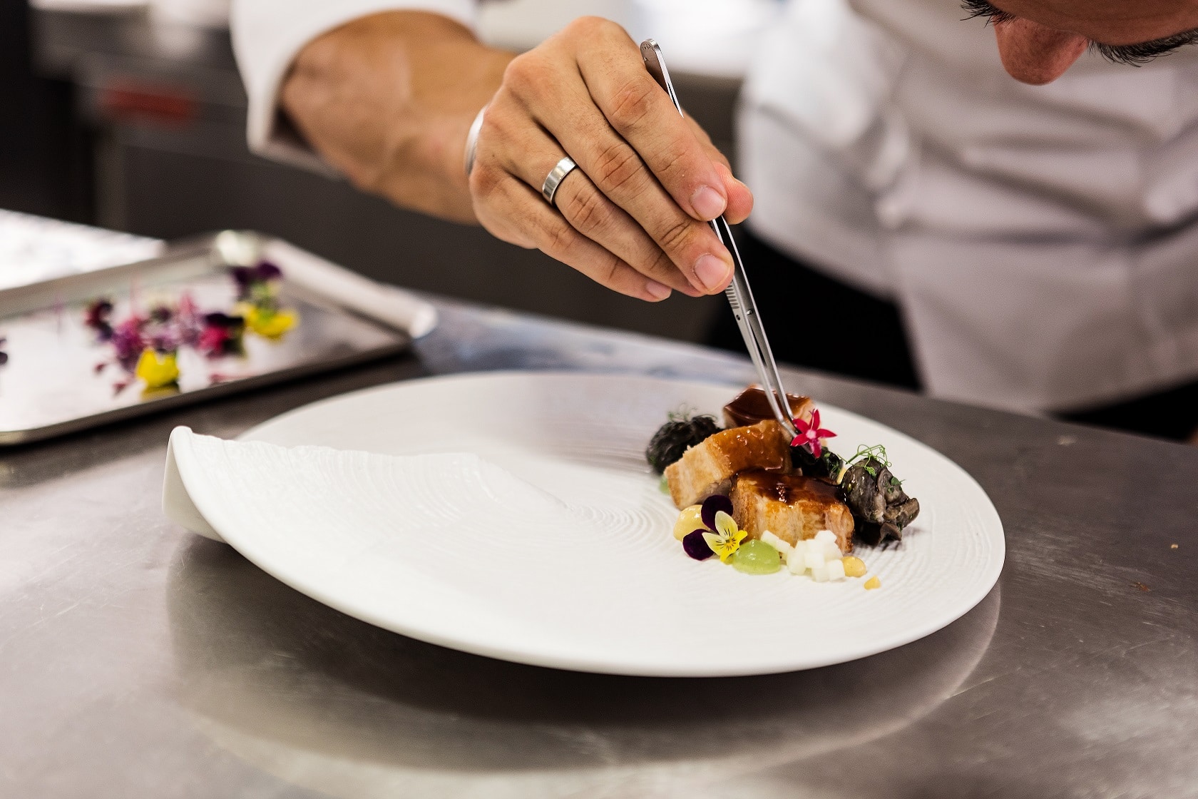 Chef finishing a plated course for a private yacht dinner