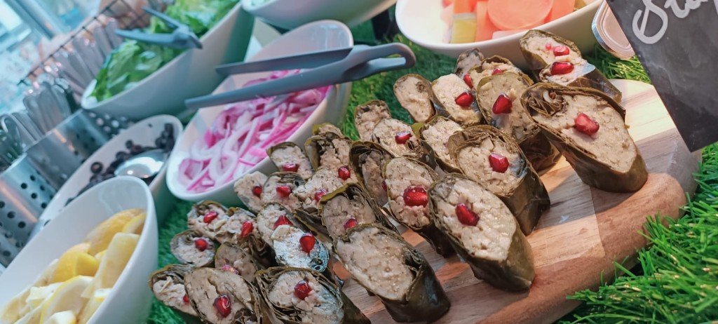 Stuffed vine leaves with pomegranate on a catering board
