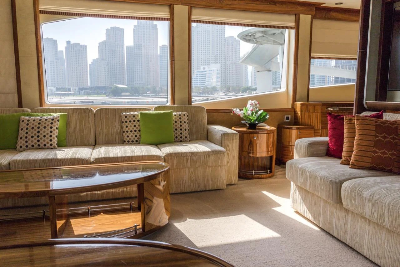 "Luxurious lounge with panoramic windows – 101 Feet Yacht by Mala Yachts, yacht rental in Dubai."