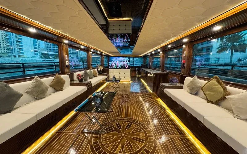 Stylish indoor sofa seating aboard Arabian Pearl Yacht for relaxed cruising – unwind with Mala Yachts yacht rental in Dubai