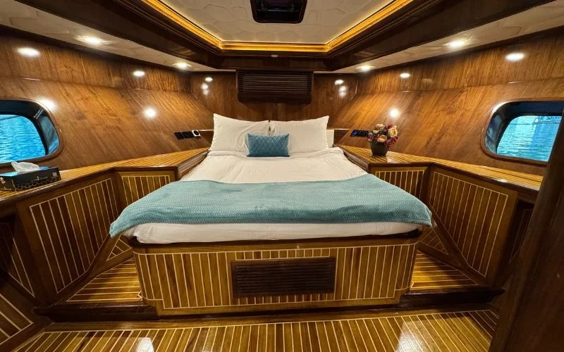 Cozy guest bedroom on Arabian Pearl Yacht with premium bedding – comfort at sea with yacht rental Dubai by Mala Yachts