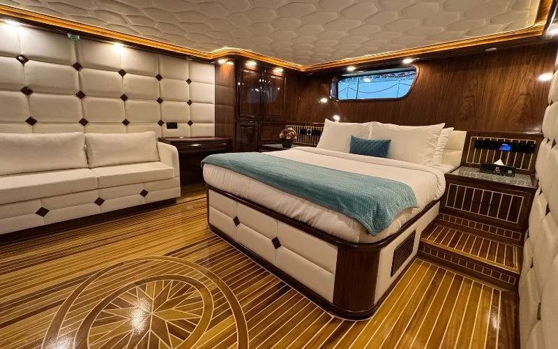Elegant master bedroom on Arabian Pearl Yacht featuring warm lighting and sea views – luxurious escape with Mala Yachts yacht rental in Dubai