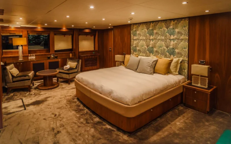 Spacious master bedroom on Lucien 131 yacht with sea-facing windows – premium comfort with Mala Yachts’ yacht rental Dubai