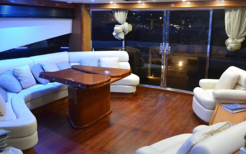 Luxurious salon inside Black Beauty Yacht with leather seating and soft ambient lighting