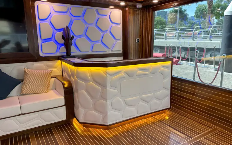 Luxurious interior lounge of Orchid yacht with elegant seating – yacht rental in Dubai by Mala Yachts