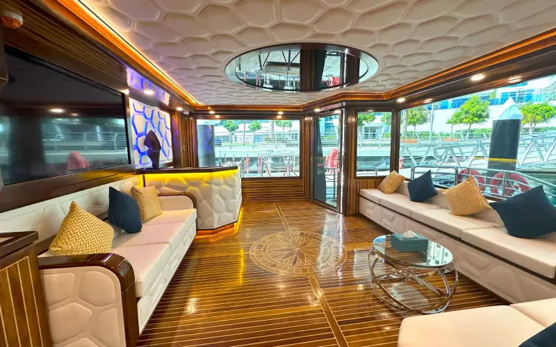 Spacious lounge area inside Orchid Yacht with luxurious seating and modern décor