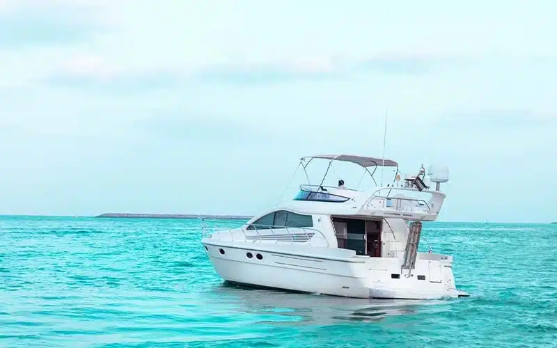 Side view of Wrong 2 Yacht anchored near the marina with large panoramic windows and glossy white hull