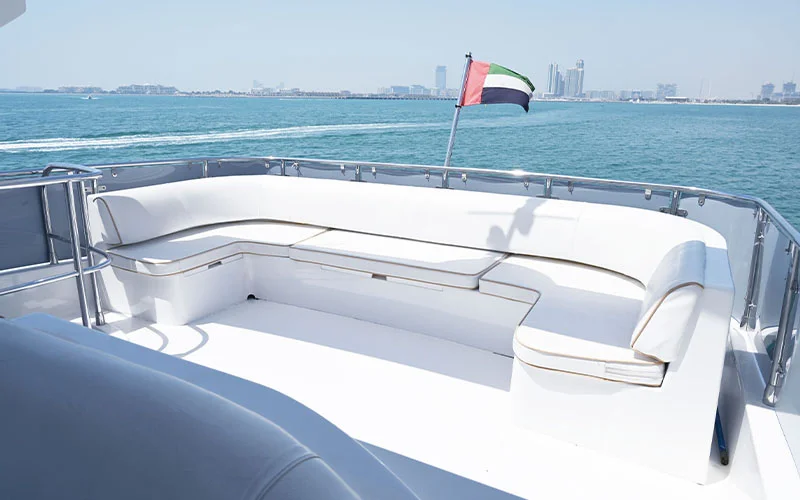 Outdoor dining area on Maze Yacht’s aft deck with teak flooring and cushioned seating