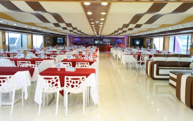 Formal dining setup with high-back chairs and elegant tableware in Lotus Royale Yacht