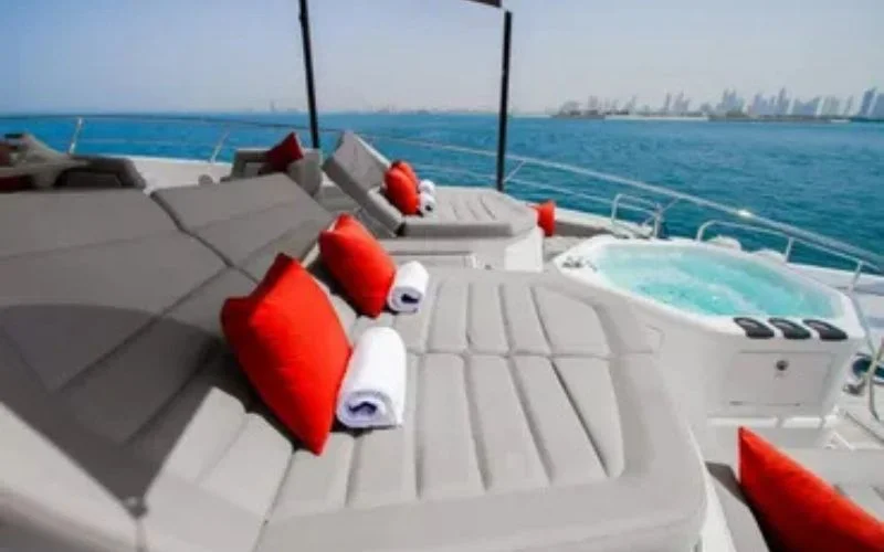 Guests sunbathing on the open deck of Legende Yacht with ocean views