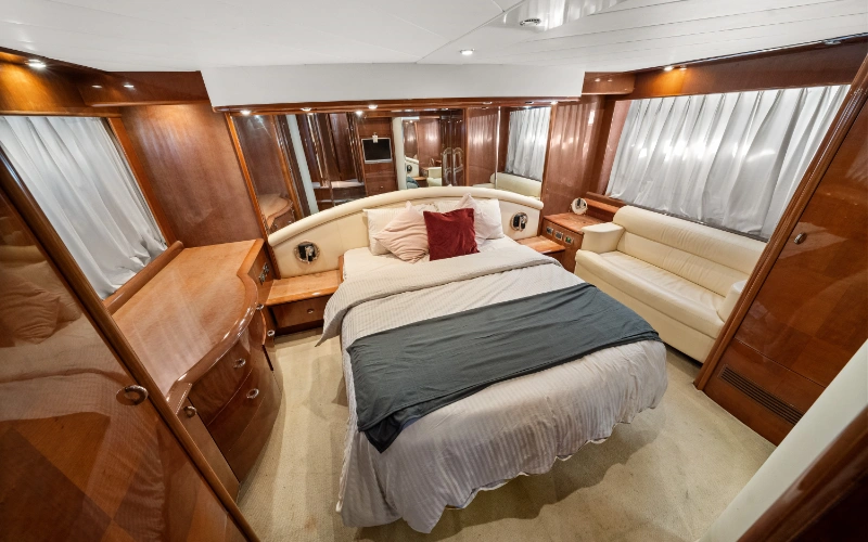 Cozy bedroom cabin on the Gulf Craft 60ft yacht with refined design and soft bedding – Mala Yachts provides relaxing escapes with yacht rental in Dubai.