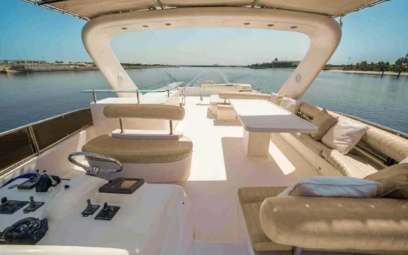 Stylish lounge inside the Kronos yacht featuring premium seating and ambient lighting – Mala Yachts delivers high-end yacht rental in Dubai for private relaxation.