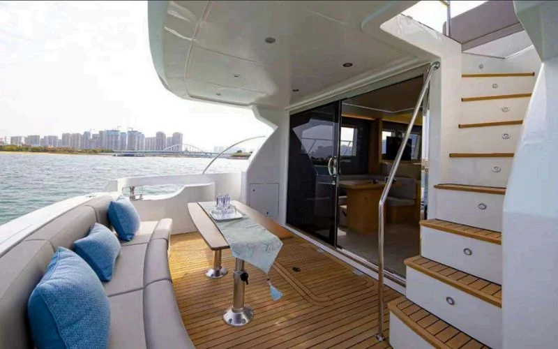 Open-plan dining and lounge space aboard the Meridian 45ft yacht for versatile comfort – dine, relax, and cruise with Mala Yachts’ yacht rental in Dubai.