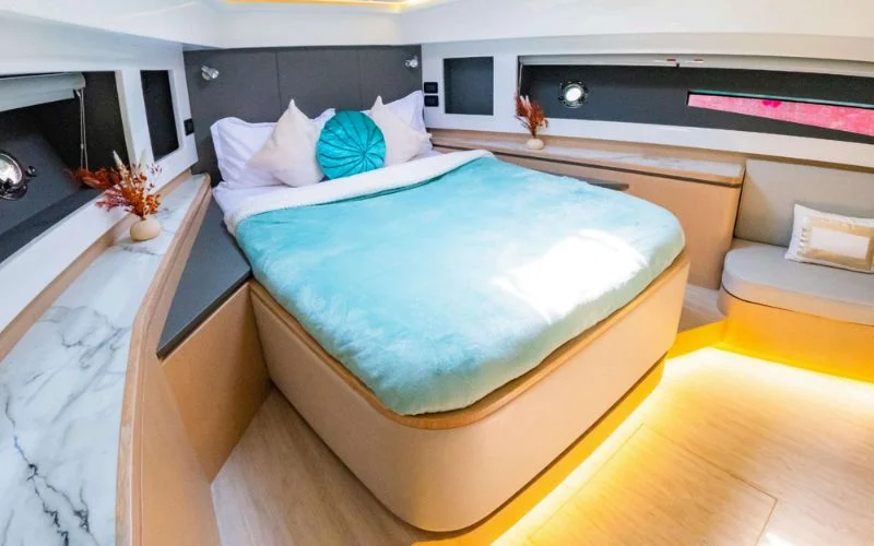 Cozy bedroom cabin aboard the Meridian 45ft yacht designed for restful comfort – overnight yacht rental in Dubai made luxurious by Mala Yachts.