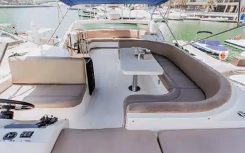 Beautiful dining area aboard the Vassia yacht with elegant table setting – experience refined yacht rental in Dubai with Mala Yachts.