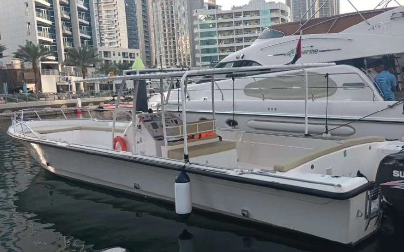 Sleek side profile of Dubai Marine 32ft yacht cruising in Dubai – yacht rental Dubai by Mala Yachts