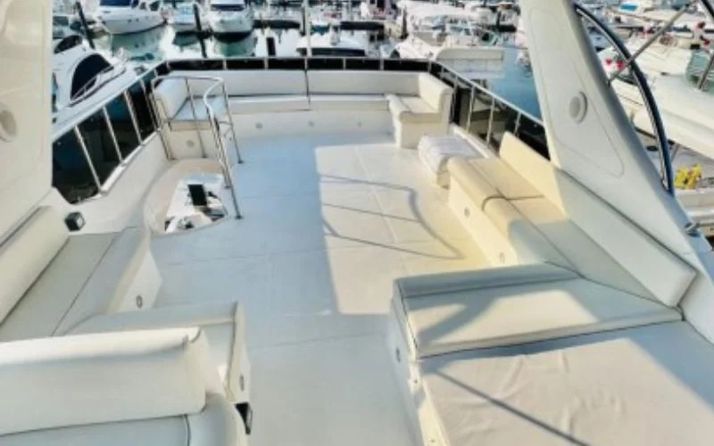 Majesty 70ft yacht’s outdoor lounge with stylish furniture and shaded seating area – enjoy alfresco moments with Mala Yachts’ premium yacht rental in Dubai.