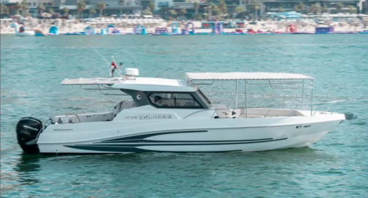 Luxury center-console boat cruising on calm sea with shaded canopy