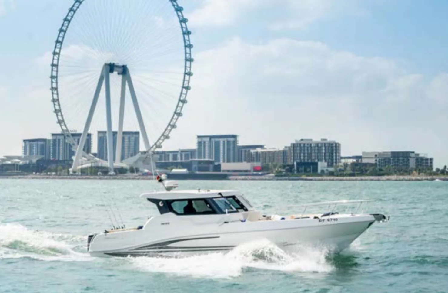 Luxury speedboat cruising near Ain Dubai with waterfront skyline