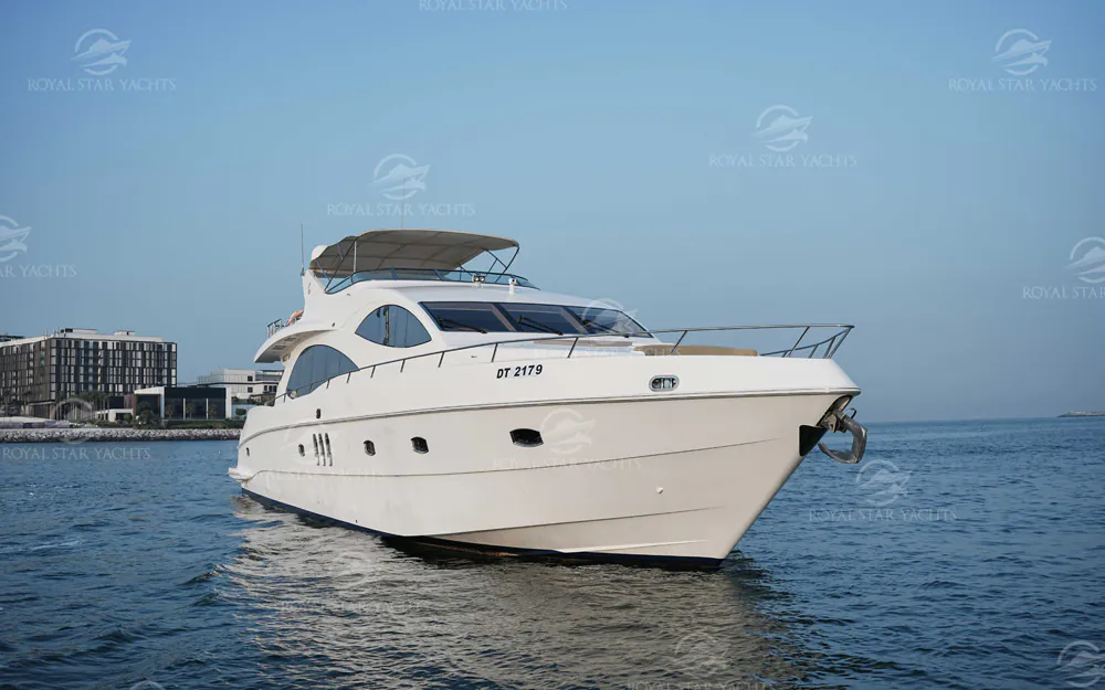 Luxury motor yacht cruising on calm sea under clear skies, showcasing a modern white yacht design.