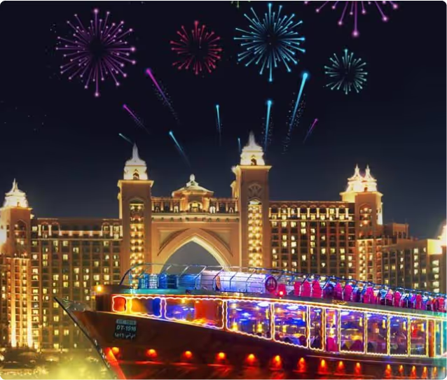 Luxury dhow cruise illuminated at night with fireworks over Atlantis The Palm in Dubai.