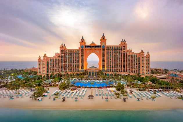 Atlantis The Palm crescent approach Atlantis The Palm resort and private beach at golden hour on the Dubai yacht route
