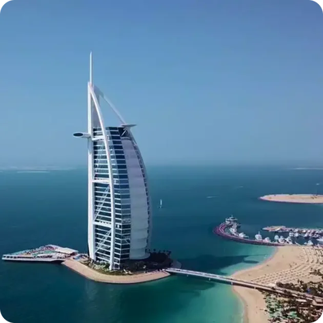Burj Al Arab from the water Aerial view of Burj Al Arab sail hotel on its private island along the Dubai coastline yacht route