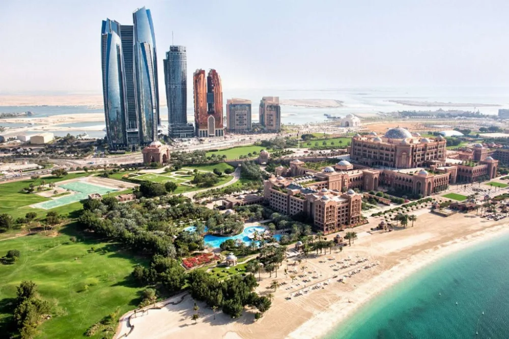 Emirates Palace from the water Aerial view of Emirates Palace hotel, beach and Etihad Towers on the Abu Dhabi yacht route
