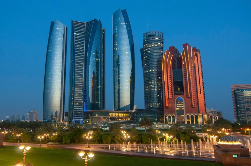 Etihad Towers coastline approach Etihad Towers illuminated at dusk in Abu Dhabi, a landmark on the capital yacht cruise route