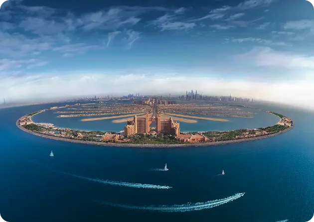 Palm Jumeirah from a Dubai yacht route Aerial view of Palm Jumeirah island and Atlantis crescent on a Dubai yacht sightseeing route